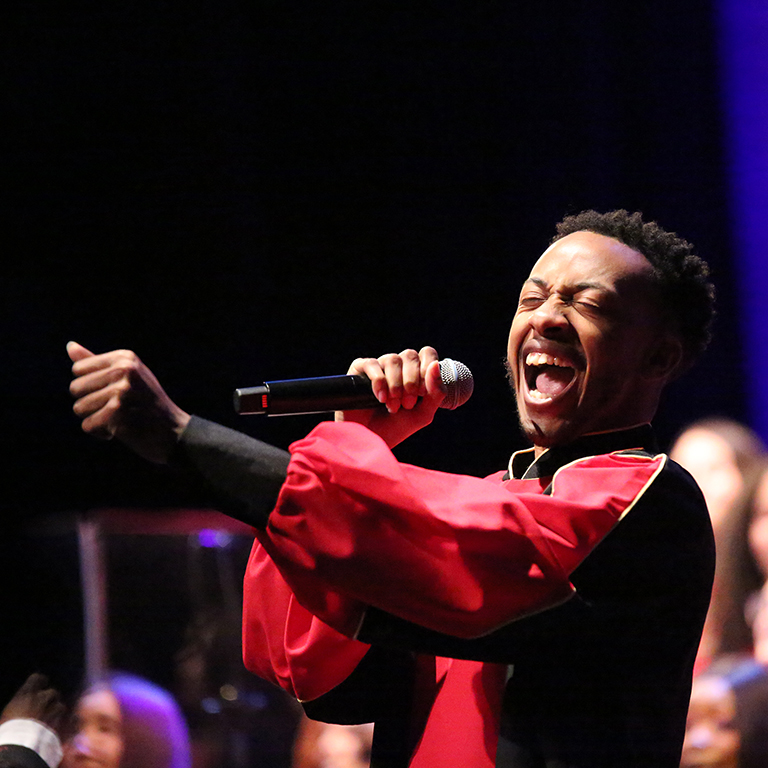 A male soloist sings with the African American Choral Ensemble